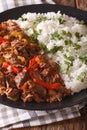 Ropa vieja: beef stew in tomato sauce with vegetables and rice g