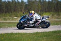 10-05-2020 Ropazi, Latvia young man riding motorcycle in asphalt road curve Royalty Free Stock Photo