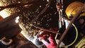 Rope access abseiler worker wearing a fall industrial safety harness helmet, red welding safety leather glove dark face shield Royalty Free Stock Photo