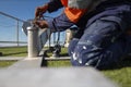 Engineer inspecting clipping Karabiner which attached on rope into portable lightweight abseiling tripods counter weight