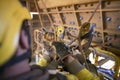 Rope access miner commencing rope transferring using descender maneuvering from left to right Royalty Free Stock Photo