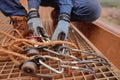 Rope access miner level 3 technician wearing a safety glove conducting safety auditing checking descender