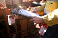 Rope access miner supervisor inspecting and checking name list on isolation permit holder box ensure all construction miners are l Royalty Free Stock Photo