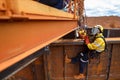 Rope access painter abseiler applying spray rustproof paint