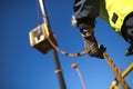 Rope access rigger worker commencing high risk job wearing heavy duty glove holding a safety tag line rope to control a load