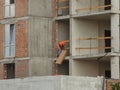 Rope access rigger worker commencing high risk job wearing heavy duty glove holding a safety tag line rope to control a load while