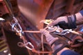 Rope access technician hand wearing a safety glove performing inserting 10.5 mm low stretch strength rope