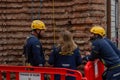 Technicians from Acrobatica secure the final rigging lines on the church wall before an aerial art performance, in Alba, CN, Italy Royalty Free Stock Photo