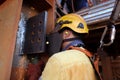 Rope access welder wearing helmet safety harness fall protection using ear plug noise protection while grinding weld plate Royalty Free Stock Photo