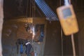 Rope access welder wearing safety equipment, harness helmet doing hot work, welding in confined space which have blurry gas test d