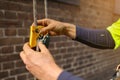 Rope access worker inserting self controller stopper a fall arrester safety back up device Royalty Free Stock Photo