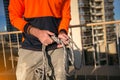 Rope access worker inspector inspecting rope rigging tie with safety bunny ears knot prior to used