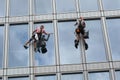 Rope access workers clean windows in office building