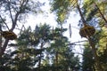 Rope adventure park in a summer forest scenic blue sky scenery. Overcoming obstacles and reaching heights abstract concept