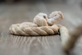 a rope is being rolled up on a table top with its knot exposed