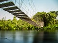 Rope bridge across river. Royalty Free Stock Photo