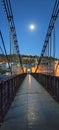 The gateway to a suspension bridge at night under moon light in Constantine, Algeria Royalty Free Stock Photo