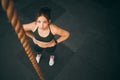 Rope climbing, gym and fitness woman with focus for sports challenge, full body workout and healthy training. Female Royalty Free Stock Photo