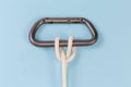 Rope clove hitch on a carabiner on a blue background Royalty Free Stock Photo