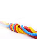 Rope, color and knot together by white background for support with strong connection, collaboration and helping. String Royalty Free Stock Photo