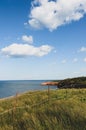 Rope fence in tall grass at the edge of the red cliffs at Prince Edward Island National Park, Canada