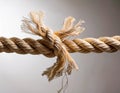 A rope fraying under tension, placed against a light backdrop emphasizing breaking points in fragile systems Royalty Free Stock Photo