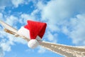 Rope hammock with Santa`s hat outdoors, closeup. Christmas vacation