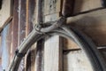 A rope hanging on the wall in a barn showing the honda knot looking very western.