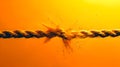 Breaking point captured in a dramatic moment, a rope fraying against a sunset backdrop. Symbolic of stress, tension, and Royalty Free Stock Photo