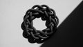 Rope knot is formed into a circular woven pattern casting a detailed Royalty Free Stock Photo