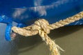 A rope knot hanging on a blue boat