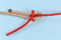 Rope knot Heaving line bend on a blue background