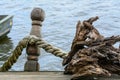 Rope knotted along a ship bollard. Docks with rope in harbor, bl Royalty Free Stock Photo