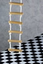 Rope ladder and floor background black and white square cage.Rope ladder-wooden steps, convenience,simplicity,compactness, Royalty Free Stock Photo