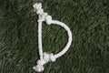 Rope alphabet on grass. Letter D