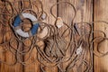 Rope and lifebuoy on old wooden burned table or board for background Royalty Free Stock Photo