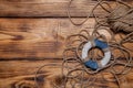 Rope and lifebuoy on old wooden burned table or board for background Royalty Free Stock Photo