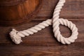 A rope lying near an old wooden barrel Royalty Free Stock Photo