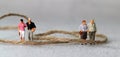 Rope and miniature people with business concept.