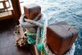 Rope for mooring a ship on a ship close-up, a nautical rope on a wooden beam on a ship. Royalty Free Stock Photo