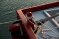 Rope and an old mooring bollard in port, up-close and in detail of the old red boat Royalty Free Stock Photo