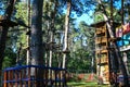 Rope park in the tall tree forest obstacle. Adventure climbing high wire park. Close-up Royalty Free Stock Photo