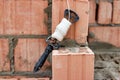 Rope plumb for even brickwork. Compliance with the correct laying of walls and corners of ceramic bricks. Bricklayer's tool Royalty Free Stock Photo