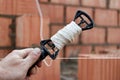 Rope plumb for even brickwork. Compliance with the correct laying of walls and corners of ceramic bricks. Bricklayer's tool Royalty Free Stock Photo