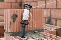 Rope plumb for even brickwork. Compliance with the correct laying of walls and corners of ceramic bricks. Bricklayer\'s tool Royalty Free Stock Photo