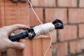 Rope plumb for even brickwork. Compliance with the correct laying of walls and corners of ceramic bricks. Bricklayer's tool Royalty Free Stock Photo