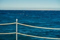 Rope railing of a landing stage in the evening light. View over the Sea Royalty Free Stock Photo