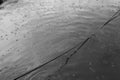 The rope and raindrops on the surface of the lake. Royalty Free Stock Photo