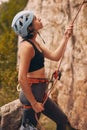 Rope, rock climber and woman mountain climbing in nature for exercise, endurance and body training outdoors. Fitness