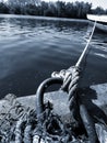 A rope with a sea knot on the pier holds the boat Royalty Free Stock Photo